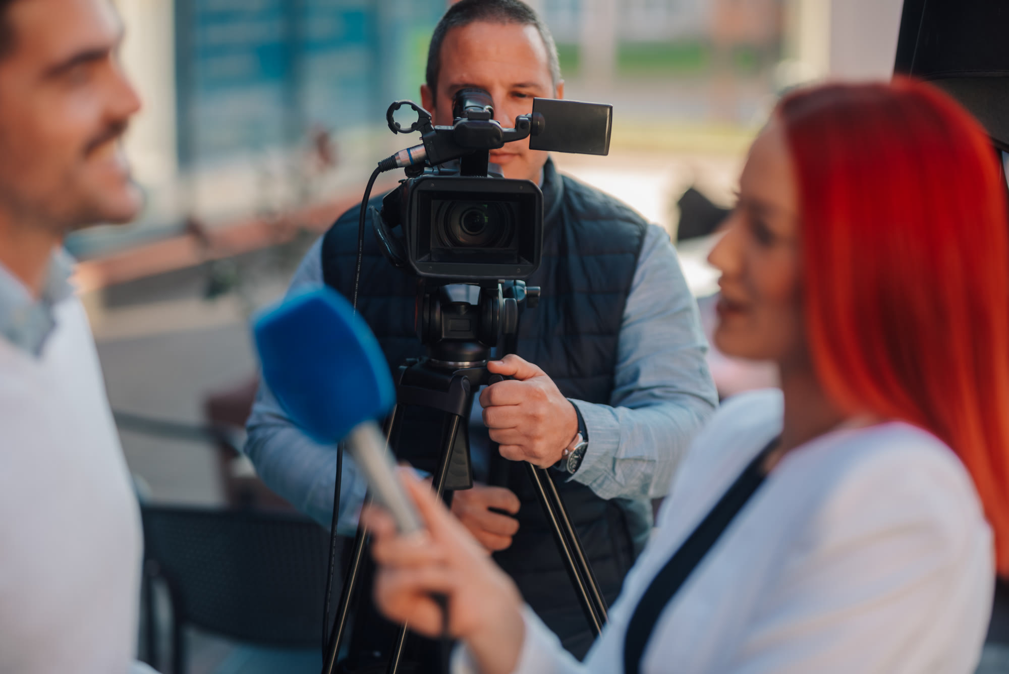 A reporter interviewing a subject with a microphone